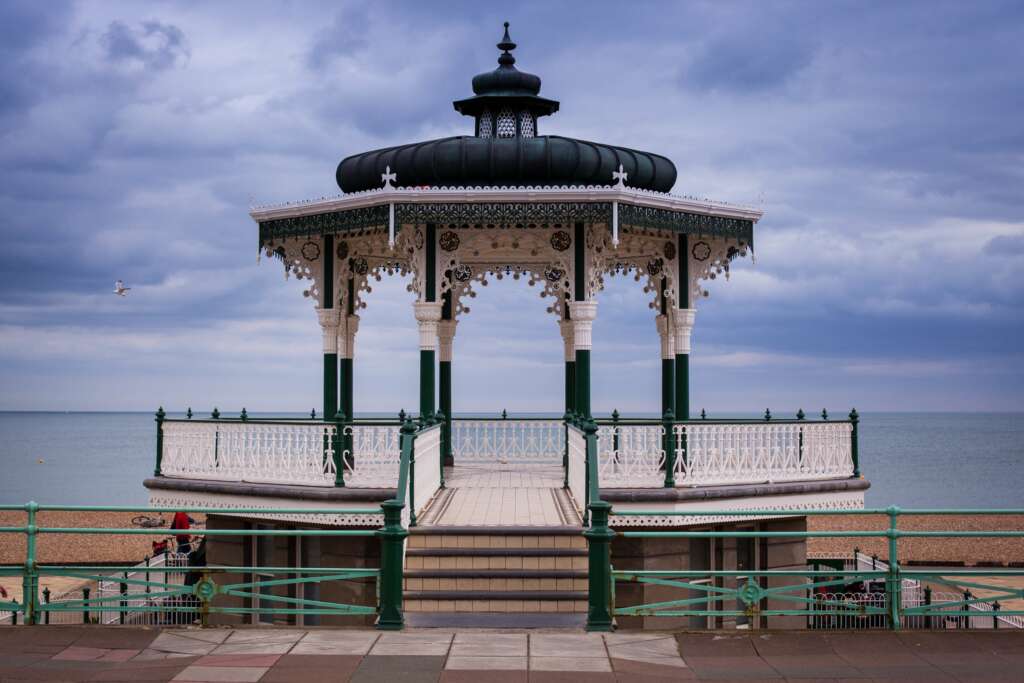 The beautiful view of the wooden bandstand over the sea in Brighton Bandstand, UK