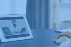 man on a tablet conducting a physiotherapy assessment